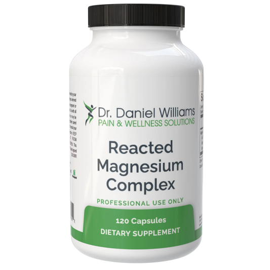 Supplement bottle labeled 'Reacted Magnesium Complex' by Dr. Daniel Williams on a gray background